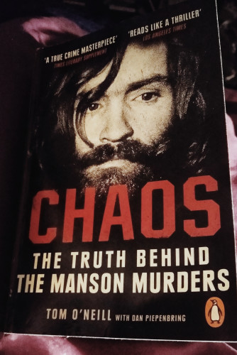 Book cover featuring photo of Charles Manson. Book title is Chaos the truth behind the Manson Murders by Tom O'Neill 