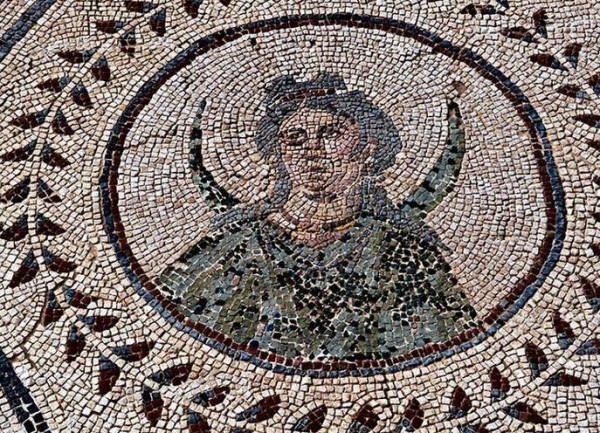 Mosaic in the House of the Planetarium in Italica, Spain, with a bust of Selene, the Moon, who gave her name to Monday. She is depicted with a top bow hairstyle and a dark robe with a lunar crescent behind her shoulders.