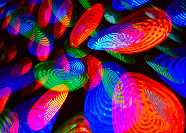 Abstract image of overlapping, distorted circles, lit in red, green and blue.