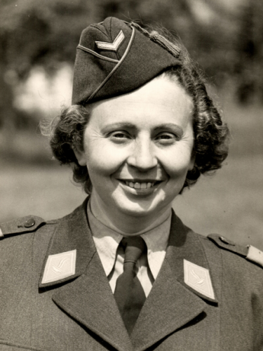 Ersilia Fossati in black & white head and shoulders photo. Photo from 1940s, she is wearing Swiss Women's Army Auxiliary Service uniform, shirt, tie, jacket and forage cap, smiling directly at camera. 