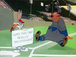 Bugs Bunny holding sign that says "Was this trip really necessary?".