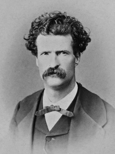 A younger picture of Mark Twain, but still with his characteristic large bushy moustache and shock of wild hair.