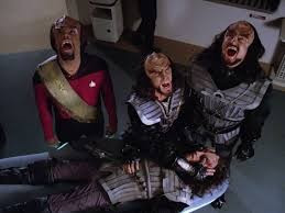 Worf and two other Klingons mourn the death of a fellow Klingon. 