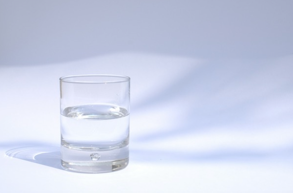 A glass of water that could be interpreted as half-full or half-empty.