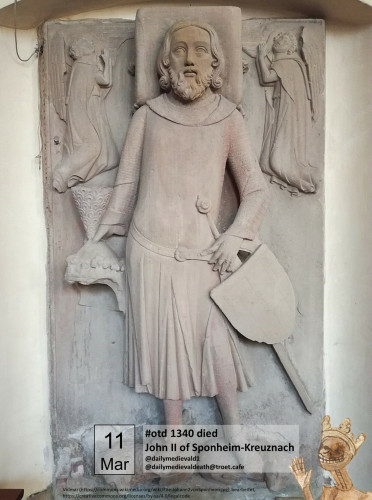 The picture shows a tomb slab with a man in a long robe with long hair and beard. He carries in one hand a helmet, in the other sword and shield