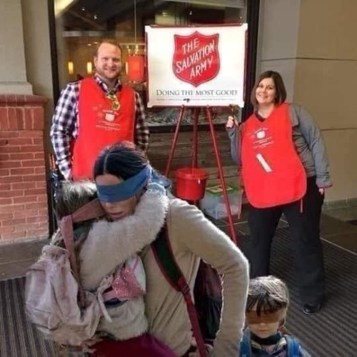 Image of Sandra Bullock from the movie Birdbox blindfolded, holding and leading two blindfolded children away from danger- photoshopped in front of a pair of people from the Salvation Army during their holiday campaign.