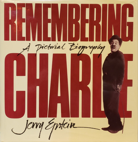 A photo of the book "Remembering Charlie – A Pictorial Biography" by Jerry Epstein.
The title, in large brown letters, fills the cover. Subtitle and author are printed in script between and below. A full length photo of Charlie Chaplin, as his silent film character, "the Little Tramp,"is superimposed over the title along the right side. 
This large book's color seems to have suffered a bit of sun-fading on it's left half.