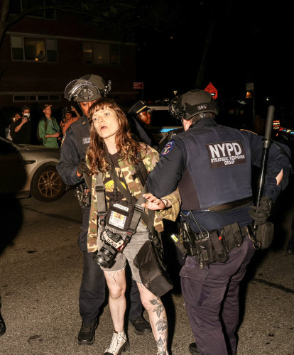 Journalist Olga Fedorova, press pass dangling, being arrested by two brave armed men from the #NYPD. Photo by Alex Kent.