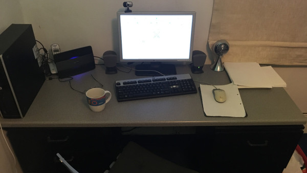This writer's desk is stripped down to the essentials: computer, chair, cup of tea.