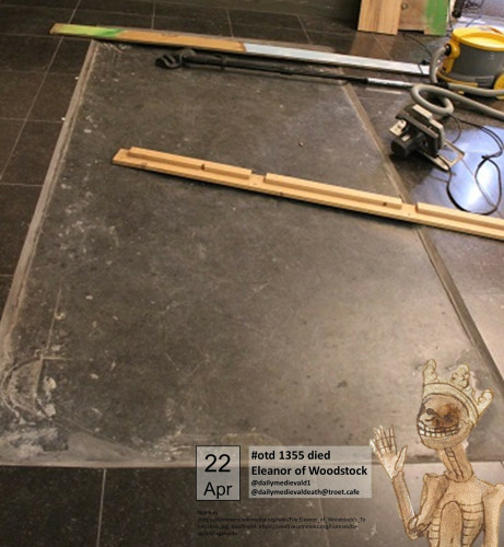 a grave slab embedded in the ground - and some modern construction tools