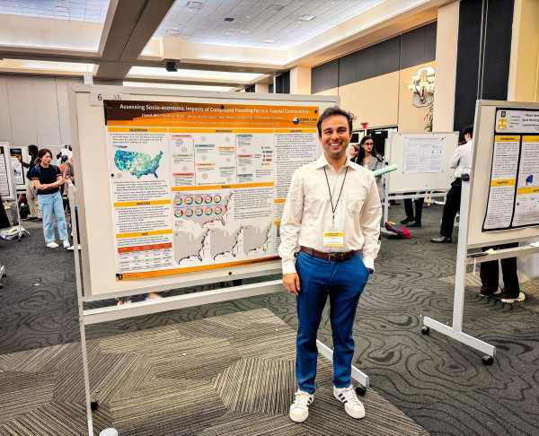 A man standing in front of a scientific poster presentation at a conference.