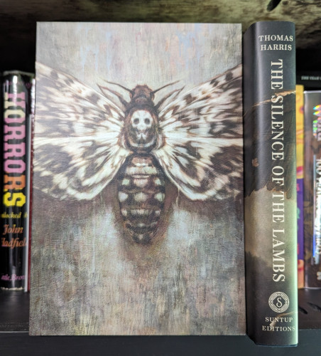 Suntup Edition of The Silence of the Lambs. The slipcover has an illustration of a Death's Head Moth on the cover, and the book itself is shown to the right.