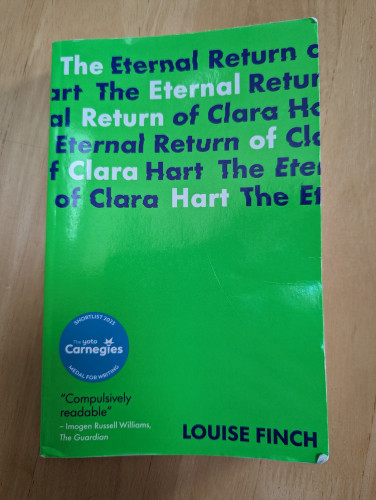 The front cover of "The Eternal Return of Clara Hart" by Louise Finch. It is bright green with the title written many times at the top  