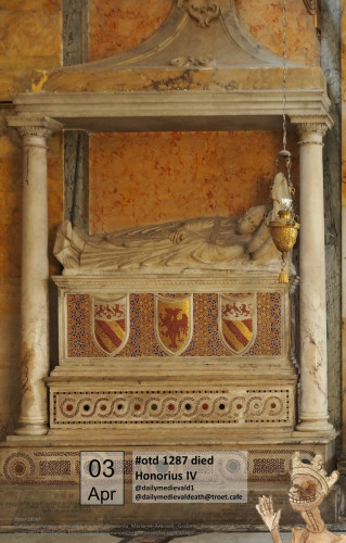 The picture shows a tomb with a reclining figure wrapped in papal robes.