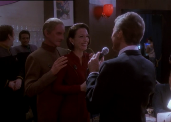 In the holosuite lounge Vic Fontaine sings to Odo & Kira. O'Brien & Bashir are in the background

And that laugh that wrinkles your nose
It touches my foolish heart