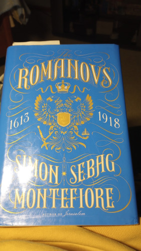 A book cover with a coat of arms and the words Romanovs:1613 (to) 1918 and the author Simon Sebag Montefiore