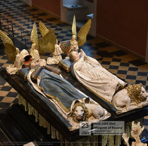 The picture shows two lying tomb figures side by side, one female the other male.