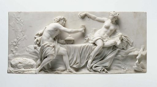 Neoclassical marble relief of Dionysos or Bacchus and Aphrodite or Venus. Both are seated on a bed couch or otherwise draped surface and sharing a cup of wine.
