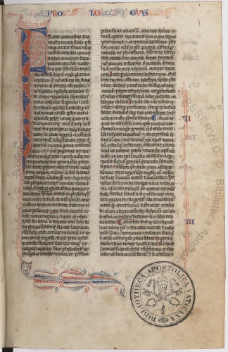 A page of gothic text in 2 columns, with a large F at top left.  Red/blue penwork.  Urb.lat.589 f.1r