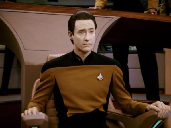 Data from Star Trek Sitting in a cahir on the bridge looking confident