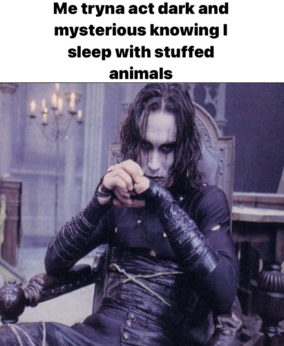 Picture of Eric Draven (Brandon Lee) from the original Crow movie sitting in a chair with text that says "me tryna act dark and mysterious knowing I sleep with stuffed animals"