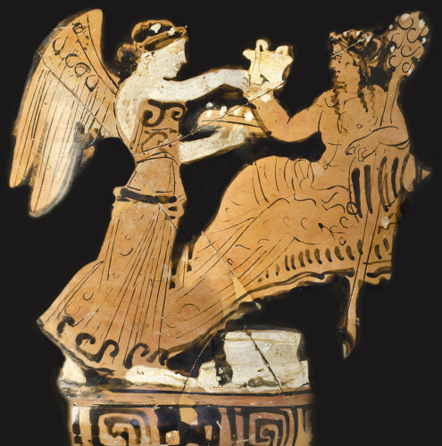 Detail of a red-figure vase painting. It shows Dionysos seated on a couch and leaning on a plump cushion, his thyrsos staff in his left arm and his kantharos cup in his right hand. He is dressed only in a himation, wrapped around his hips like a long skirt. His long hair is decorated with ribbons. Nike is winged, wearing a peplos dress. She is carrying what could be a libation bowl. Her right hand seems to grasp for the kantharos cup offered by Dionysos.