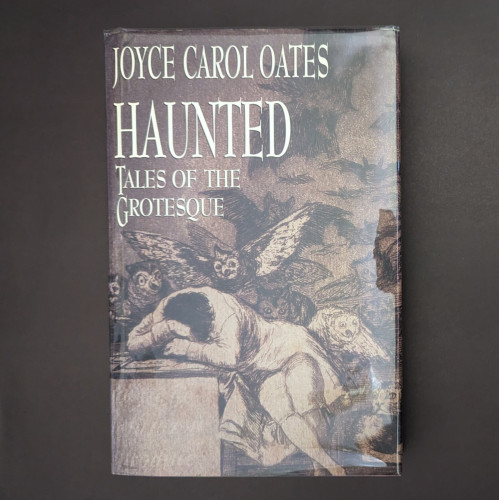 Hardcover of Joyce Carol Oates' HAUNTED: TALES OF THE GROTESQUE 
The cover is Goya's The Sleep/Dream of Reason Produces Monsters, which has a person slumped at a desk while owls attack/linger around them.