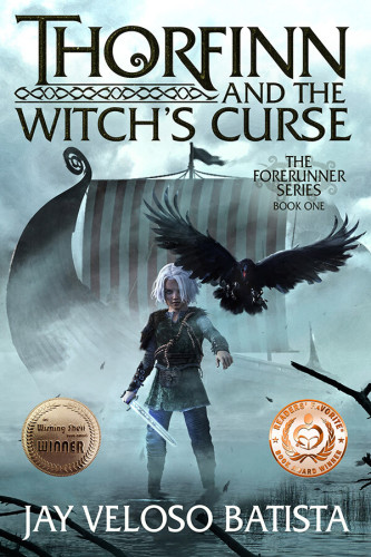 Thorfinn and the Witch's Curse (The Forerunner Series Book 1), by Jay Veloso Batista. A young boy with white hair, wearing travel-worn clothing and gripping short sword marked with Nordic runes. He stands in shallow water with a Viking ship behind him, the boat partially obscured by mist. Above his left shoulder, an enormous black raven flies toward the viewer, wings outstretched, and talons splayed to seize. Golden seals for: "Wishing Shelf Book Award Winner" and  "Reader's Favorite Book Award Winner."
