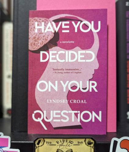 Cover of HAVE YOU DECIDED ON YOUR QUESTION, a novelette by Lyndsey Croal. A profile of a face is shown with a cutout where the brain would be and the image of the cut-out brain is to the left of the picture.