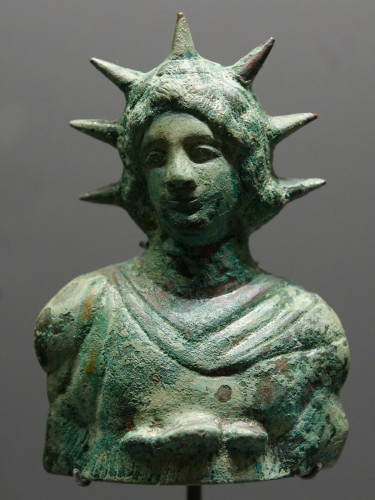 Helios (possibly Alexander) bronze bust with a 7 ray crown and long hair.