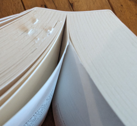 Closeup of book with pages stuck together.
