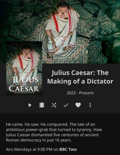 A promotional image for a television series titled "Julius Caesar: The Making of a Dictator," showing a man dressed as Julius Caesar looking upwards, with TV show details and air time on BBC Two listed below.