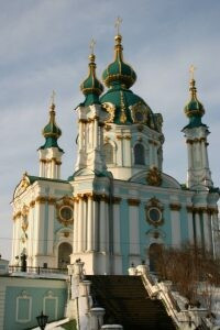 St. Andrew's Church in Kiev, Ukraine, 2006, large white church with gold trim and onion domes topping the spires.