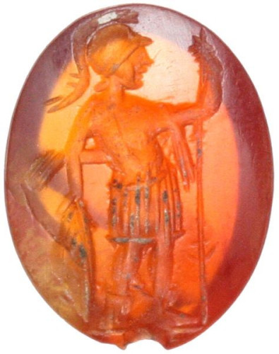 The stone depicting Ares-Mars in military dress standing facing, head left, holding spear and leaning upon round shield. Slightly convex engraved surface.