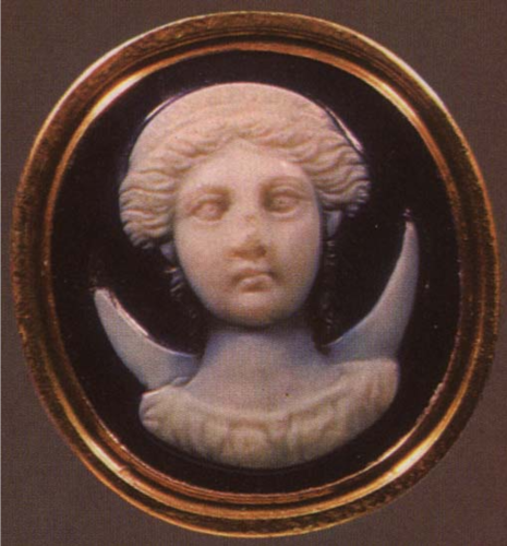 Sardonyx Cameo depicting the moon goddess Selene or Luna in frontal view. She has her hair adorned with a crown in an updo and is wearing a chiton rich in fabric. The lunar crescent behind her back identifies her as Selene or Luna.