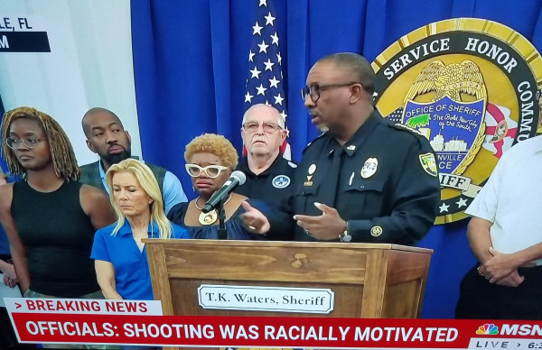 Jacksonville, Fl Sheriff department members, Mayor, and FBI at podium updating public on racially motivated mass shooting.