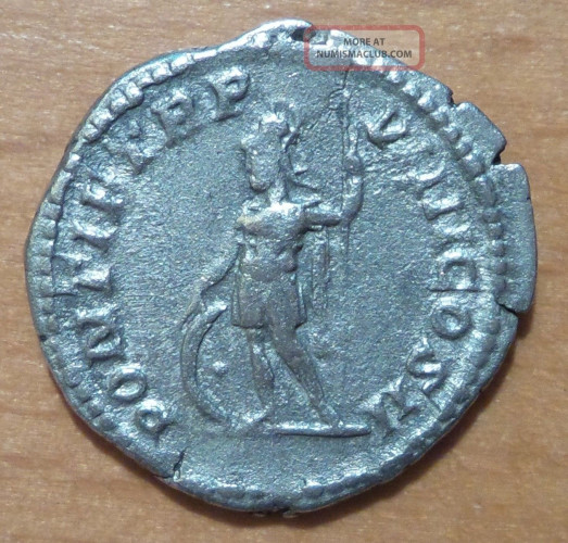 Roman silver coin depicting the god Mars, naked save for a cloak hanging from his shoulder, standing half-left, foot on helmet, holding branch and spear.