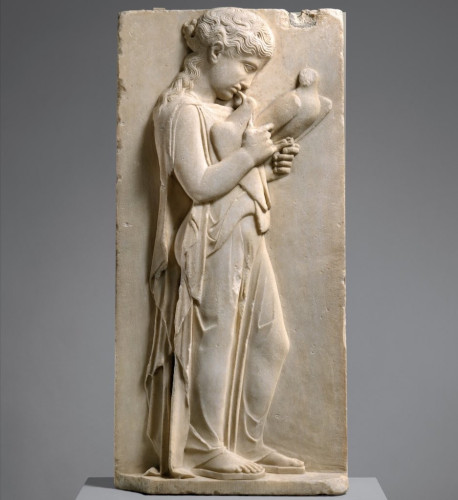 Description from the museum: “The gentle gravity of this child is beautifully expressed through her sweet farewell to her pet doves. Her peplos is unbelted and falls open at the side, while the folds of drapery clearly reveal her stance.”