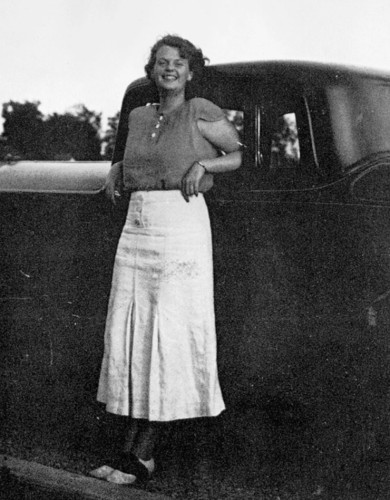 Shirley Jackson leaning against a car, smiling 