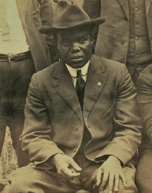 Hubert Harrison, pictured here in 1913, in a suit and fedora. By Unidentified Photographer - American Labor Museum, Public Domain, https://commons.wikimedia.org/w/index.php?curid=80055166