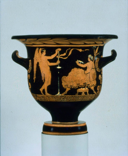 Both Eros and Dionysos are depicted as young men. Eros is in the nude, wearing just a fillet or a tiara, his wings large and going down to his knees. Dionysos is holding his thyrsos and a flat kylix cup, his head crowned with a wreath.