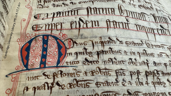 Detail of a medieval manuscript leaf: folio 61 recto in Cambridge, University Library, manuscript Ll.4.17. Visible are 10 lines of Latin script copied in black ink. 2 of the lines are copied in slightly larger display letters and underlined with red ink. Below these, the next 3 lines of text are indented to accommodate an enlarged, decorative initial ‘M’. The initial is painted in blue and red, and infilled with an ornamental network of fine, scrolling pen-work lines in red ink. The pen-work spills out of the initial into the empty margin at the left of the page. 