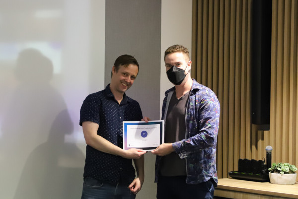 Chris getting certificate from librarian David for coming first in the UTS Visualise Your Thesis competition. 