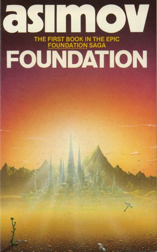 At the top of the image is the name "asimov" in large, all lowercase letters.

Beneath that, in smaller, all uppercase letters are the words
THE FIRST BOOK IN THE EPIC FOUNDATION SAGA

then underneath that in large all uppercase letters, the word
FOUNDATION

Image shows a bright sunlit scene. A sun is shining behind a tall spired building, crepuscular rays visible. The tall building is in the centre of a cluster of other similarly spired buildings, some with vagurly Kremlinesque domes. The foreground suggests a desert style landscape, and in the background behind the buildings is a jagged mountain range