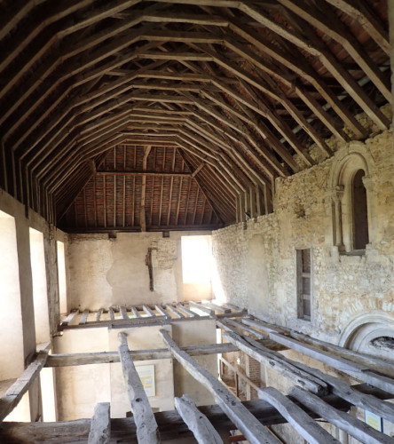 Photo of a large room with magnificent timbered roof and arched window, and the remains of a timber floor above the ground-level room below. (I understand that is thought to have been the chapel, in Marie de St Pol's rebuild; her own room is adjacent). 
Photo by Claire Barnes, 2019.