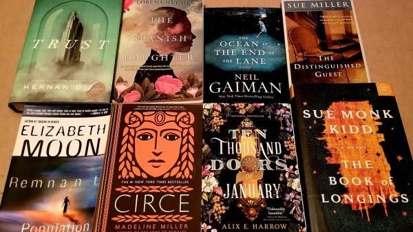 From top left, clockwise: Trust, Hernan Diaz, The Spanish Daughter, Lorena Hughes, The Ocean at The End of the Lane, Neil Gaiman, The Distinguished Guest, Sue Miller, The Book of Longings, Sue Monk Kidd, The Ten Thousand Doors of January. Alix E. Harrow, Circe, Madeline Miller, Remnant Population, Elizabeth Moon. 