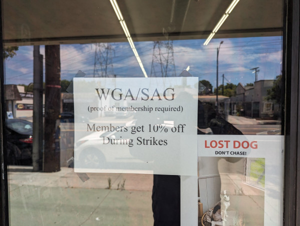 A sign reading WGA/SAG members get 10% off during strike