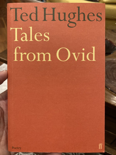 A hand holding a book, Ted Hughes’ “Tales from Ovid".