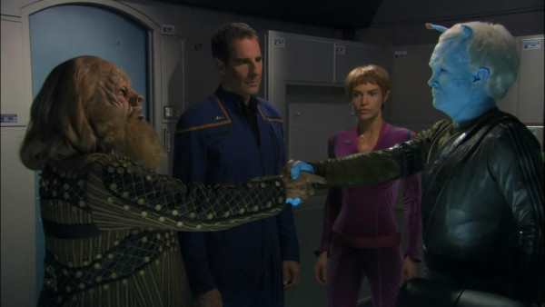 Tellarite Gral and Andorian Shran shaking hands with T’pol and Archer in background 