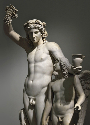 Marble statue group of Dionysos and Eros. Dioncsos raises a cluster of grapes in his right hand, his left leaning on Eros' shoulders holding a cup of wine. Eros looks back at him, winged and holding what might be a torch to light the fire in the hearts of gods and men.